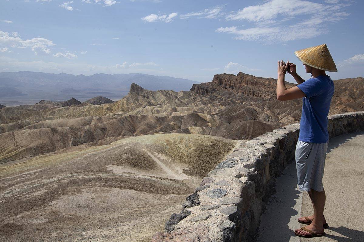 Peter Vukasin snaps a photo at Zabriskie Point in Death Valley National Park as temperatures re ...