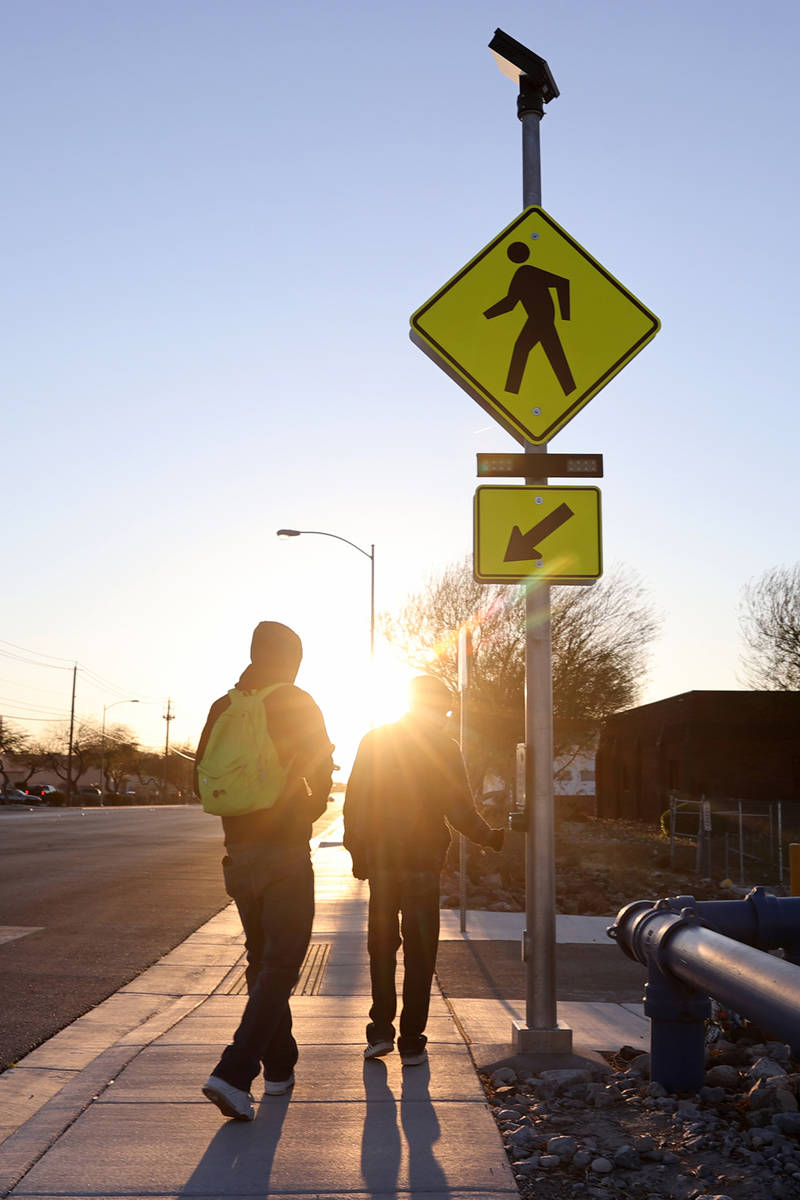 People use a crosswalk on Lone Mountain Road near Losee Road in North Las Vegas Wednesday, Marc ...