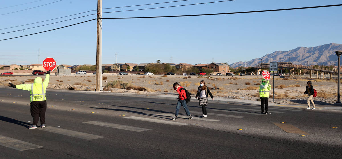 Crossing guards Ramona Redic, left, Mary Turner help Somerset Academy students at a crosswalk o ...