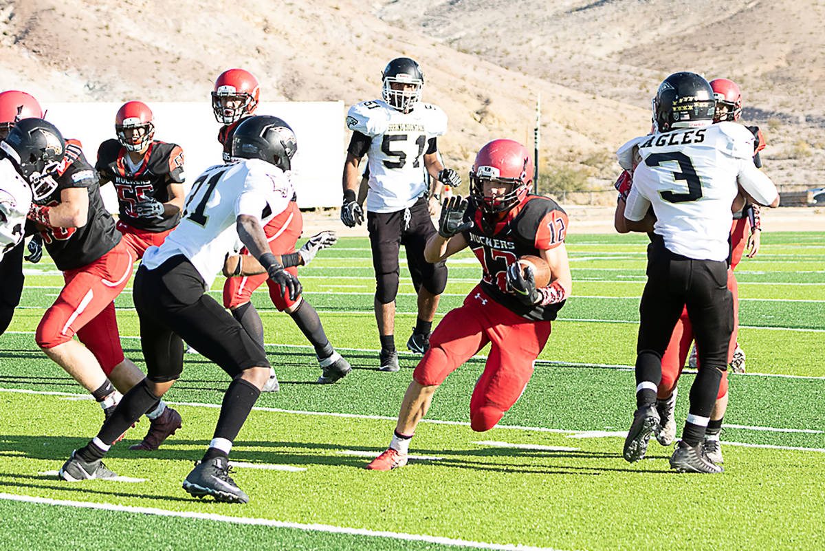 File photo Tonopah High School's Kobe Bunker looks for a hole in the Spring Mountain defense du ...