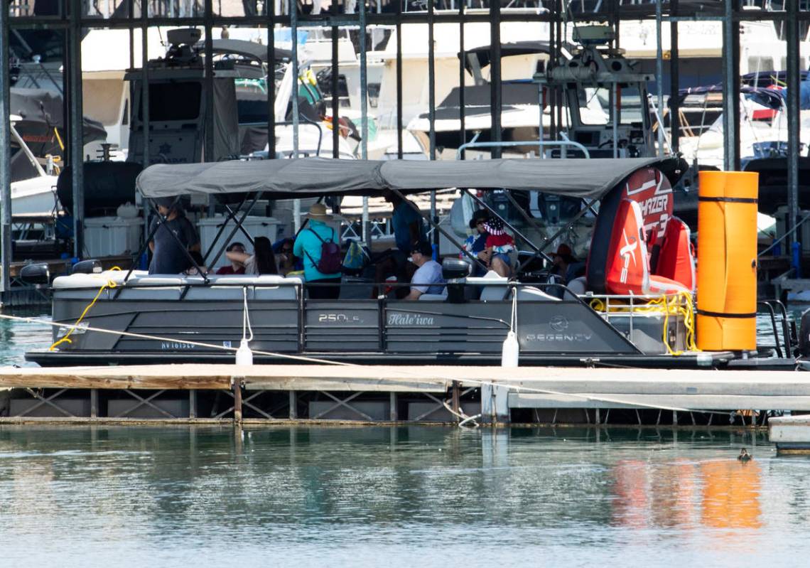 People aboard a rental boat are seen at Boulder Beach in the Lake Mead National Recreation Area ...