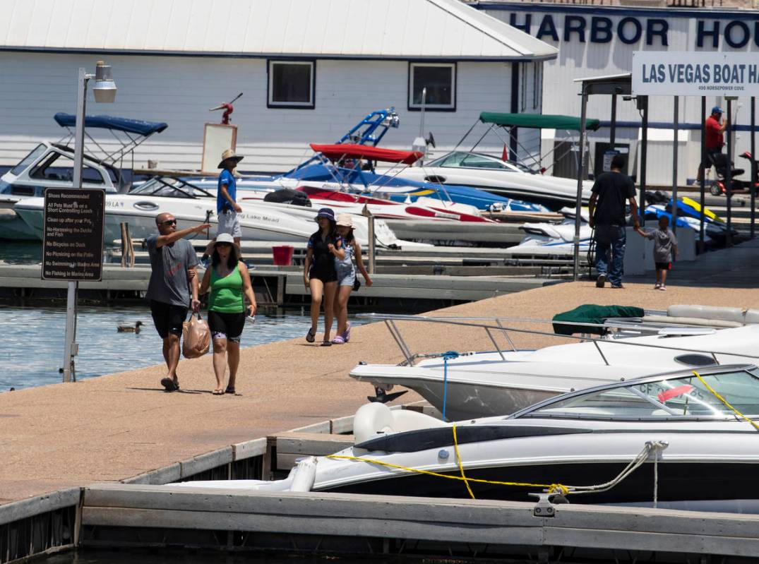 People walk on the pier at the Las Vegas Boat Harbor in the Lake Mead National Recreation Area, ...