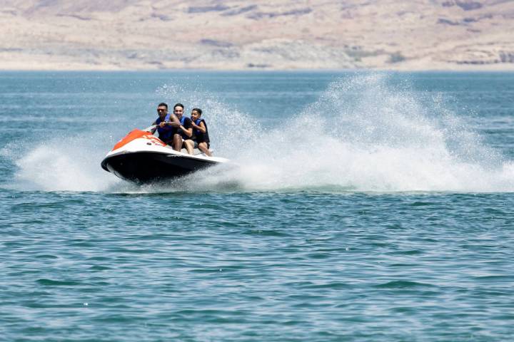 People rid their jet ski at Boulder Beach in the Lake Mead National Recreation Area, on Friday, ...