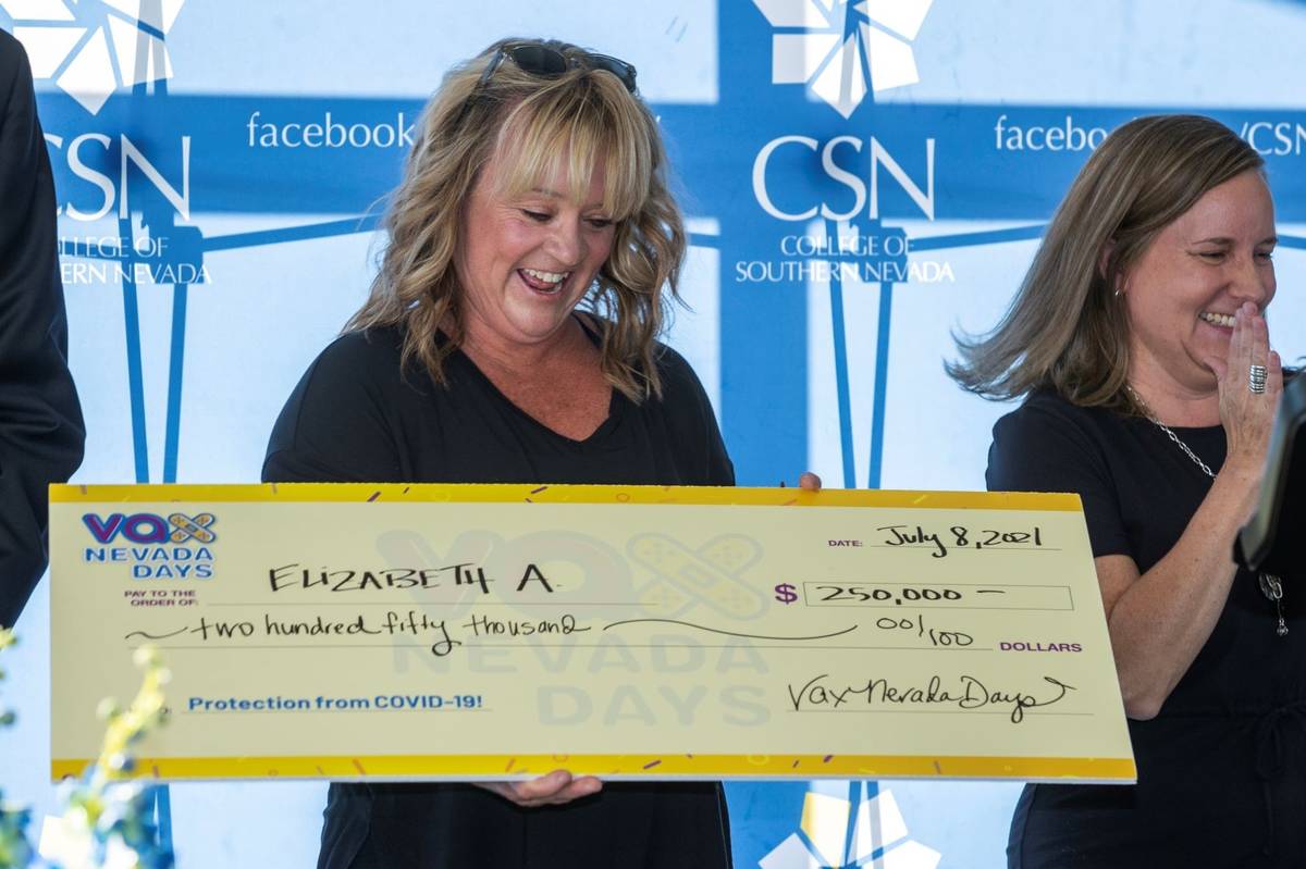 Teacher Elizabeth Allder looks to her $250,000 check as Governor Steve Sisolak and Immunize Nev ...