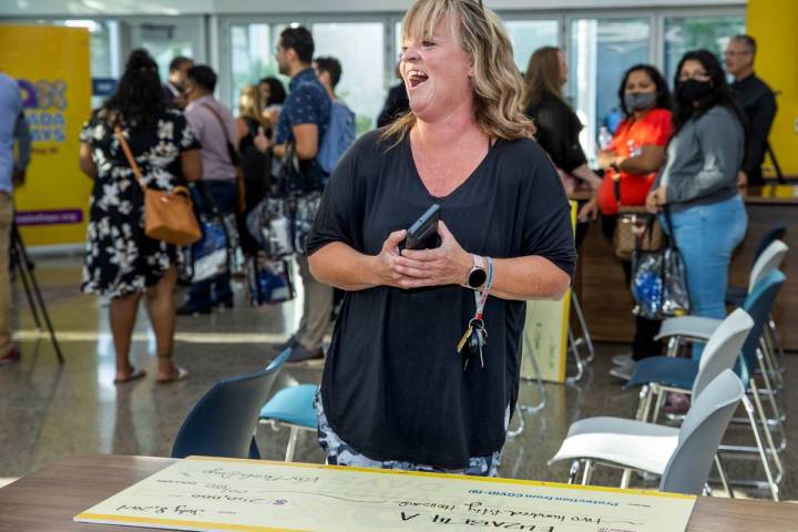 Teacher Elizabeth Allder laughs after her husband won $250,000 as Governor Steve Sisolak and Im ...