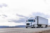 Powerful long haul big rig industrial grade diesel semi truck transporting commercial food carg ...