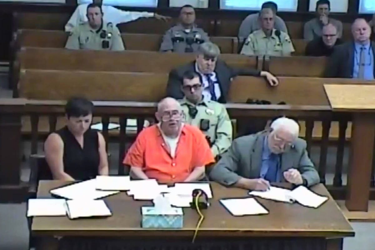 In this screenshot of a livestreamed court hearing, John Dabritz, center, is pictured alongside ...