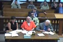 In this screenshot of a livestreamed court hearing, John Dabritz, center, is pictured alongside ...