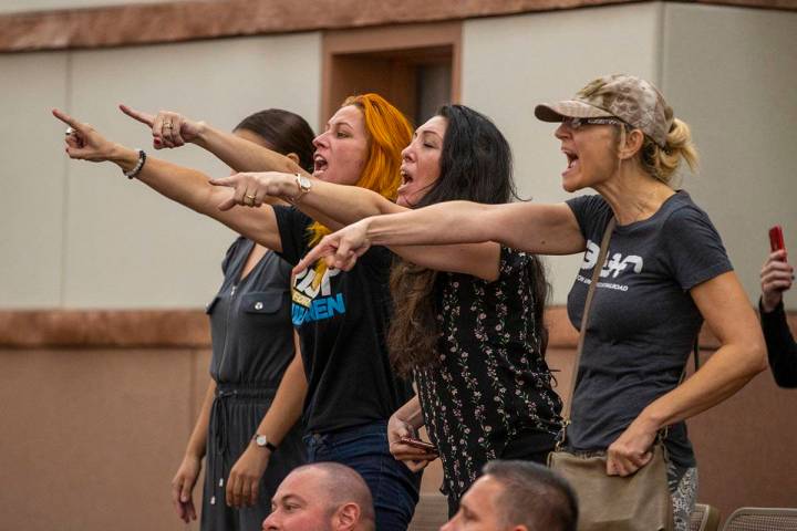 Members of the public express their discontentment as officers escort Katrin Ivanoff from the C ...