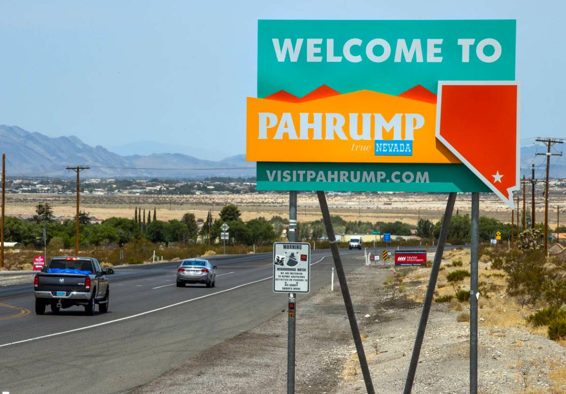 Traffic moves along at the city line for Pahrump, television station KPVM there is the setting ...