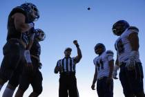 Referee Joe Molinaro flips the coin to decide kickoff between the Green Valley captains, left, ...