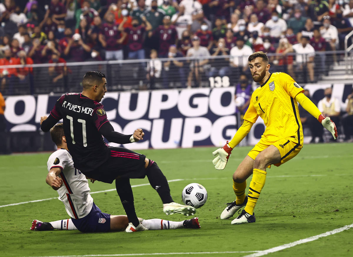 United States goalkeeper Matt Turner (1) blocks an attempt by Mexico forward Rogelio Funes Mori ...