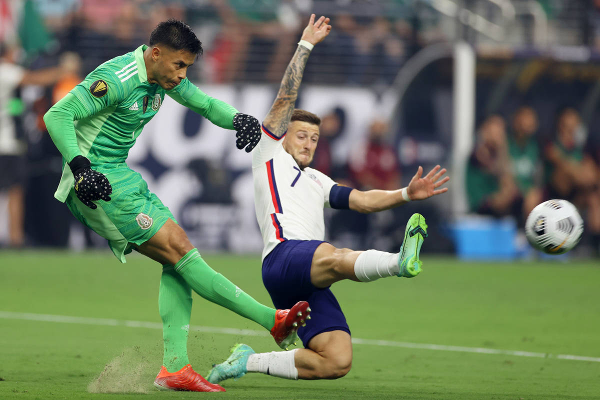 Mexico goalkeeper Alfredo Talavera clears the ball under pressure from United States forward Pa ...