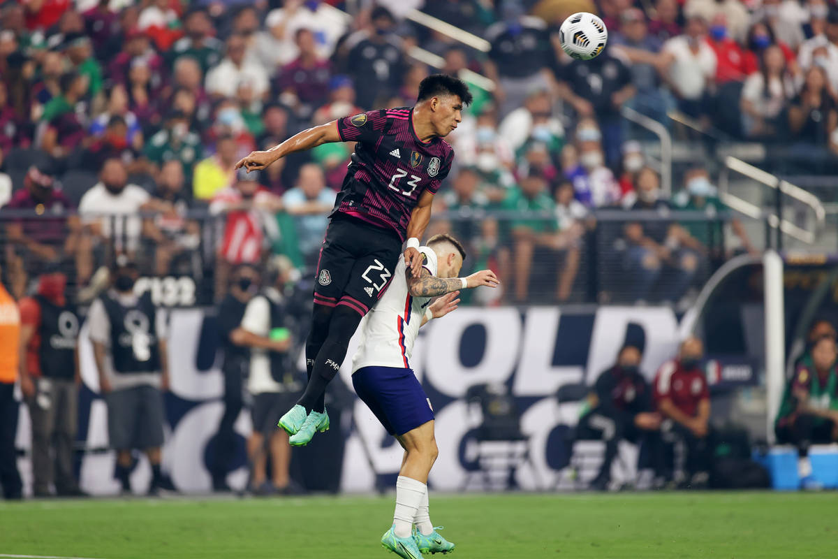 Mexico midfielder Jesus Gallardo clears the ball under pressure from United States forward Paul ...