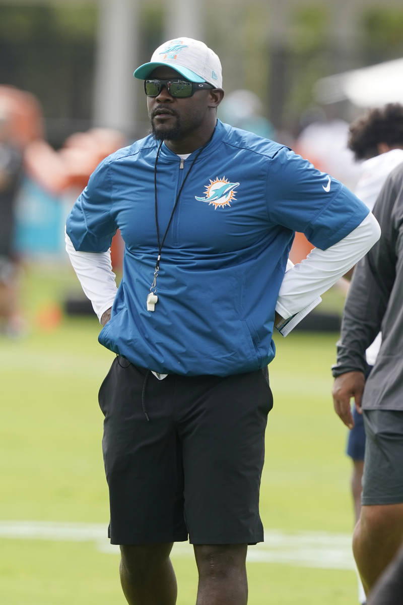 Miami Dolphins head coach Brian Flores watches the team drills during an NFL football practice, ...