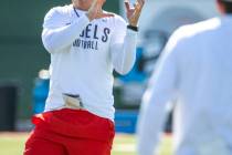 UNLV Head Coach Marcus Arroyo catches a pass from a quarterback during a drill in football team ...