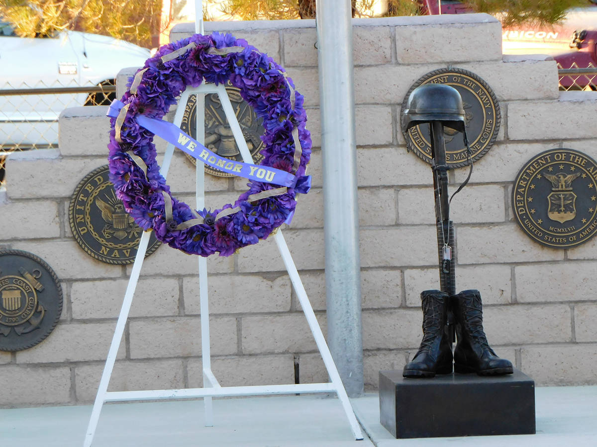 Robin Hebrock/Pahrump Valley Times A bright purple wreath and set of ID/Dog Tags representing e ...
