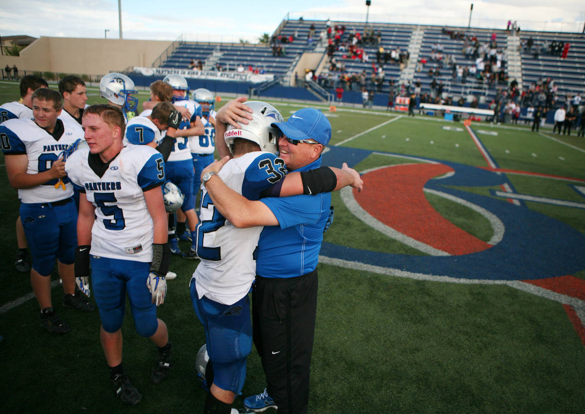 Pahranagat Valley Tyler Higbee and head coach Ken Higbee embrace after winning the Division IV ...