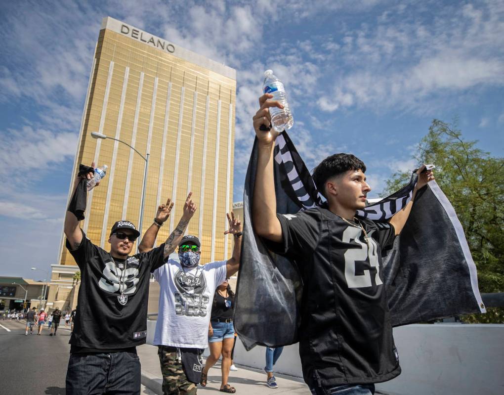 Raiders fans make their way to Allegiant Stadium before the start of an NFL preseason football ...