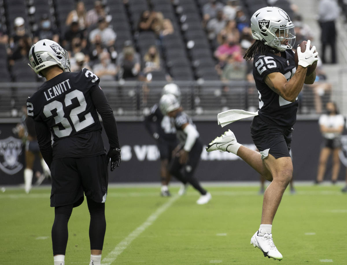 Raiders safety Trevon Moehrig (25) makes a leaping catch during a special training camp practic ...
