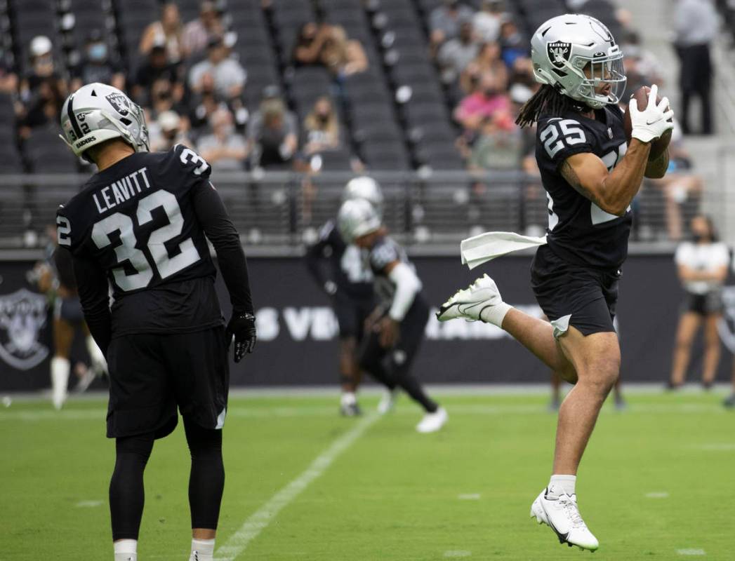 Raiders safety Trevon Moehrig (25) makes a leaping catch during a special training camp practic ...