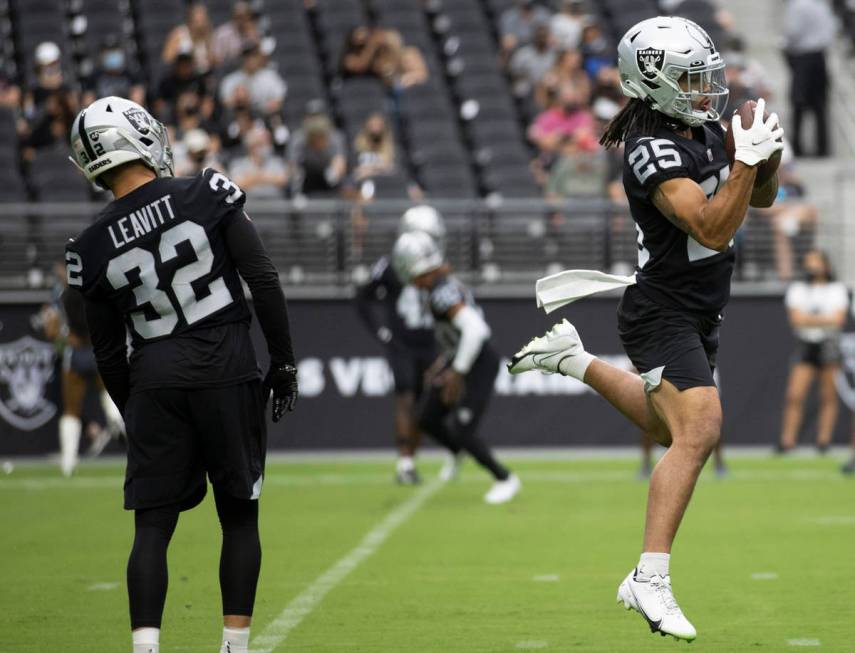 Raiders safety Trevon Moehrig (25) adjusts his head wrap during their NFL  training camp practic …