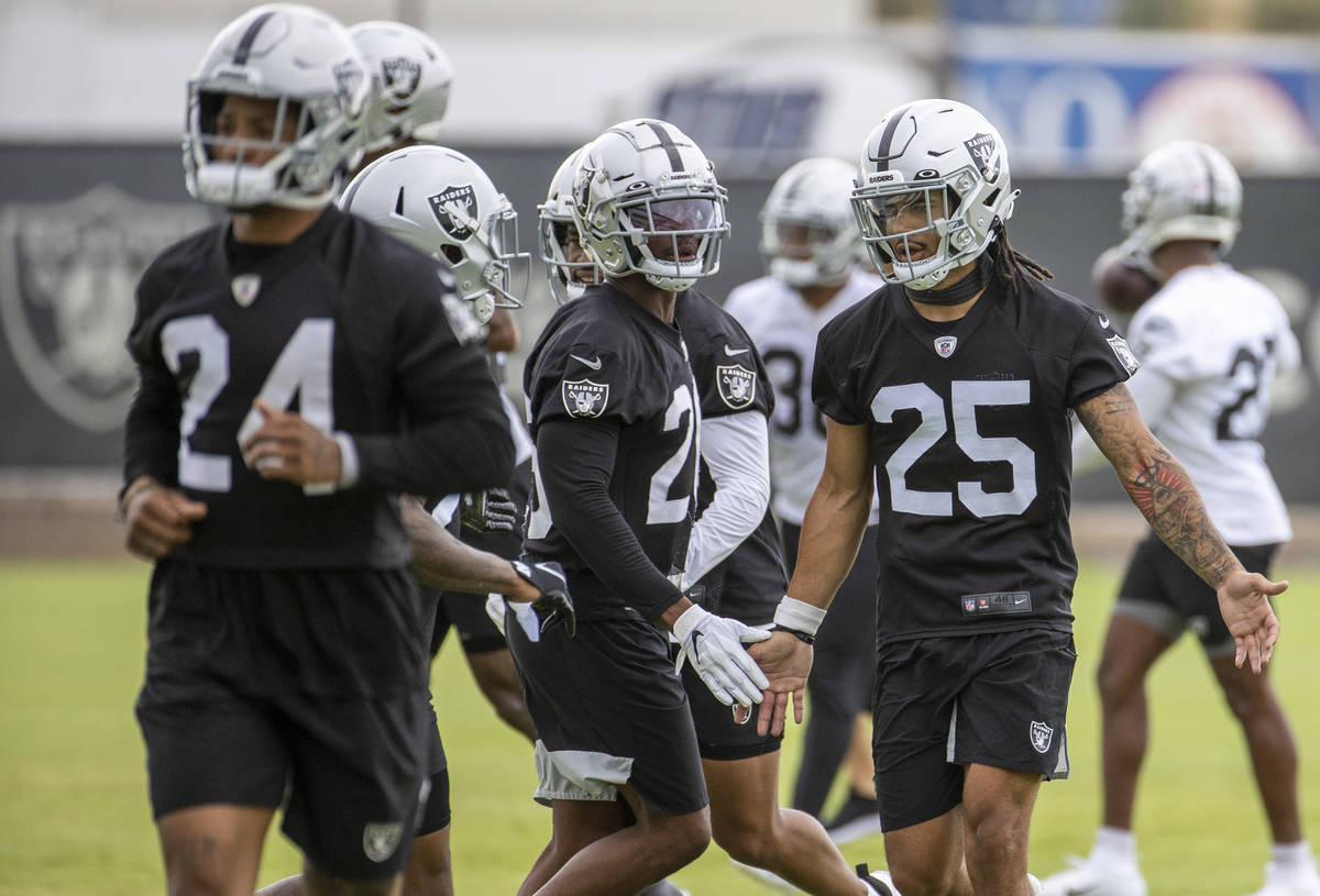 Raiders safety Trevon Moehrig (25) greets teammates on the way to stretching during training ca ...
