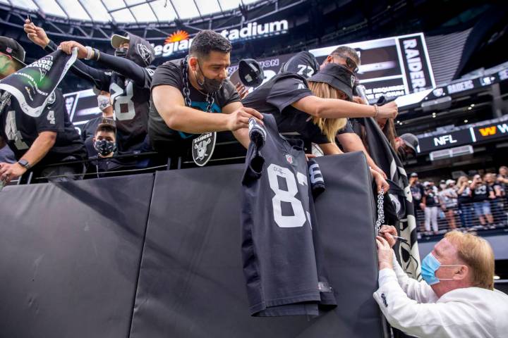 Raiders owner Mark Davis signs autographs for fans before the Raiders home opening pre-season N ...