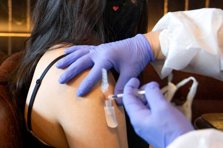 Audrey Vallapudua, of Las Vegas, receives the Pfizer COVID-19 vaccine during a pop-up vaccinati ...