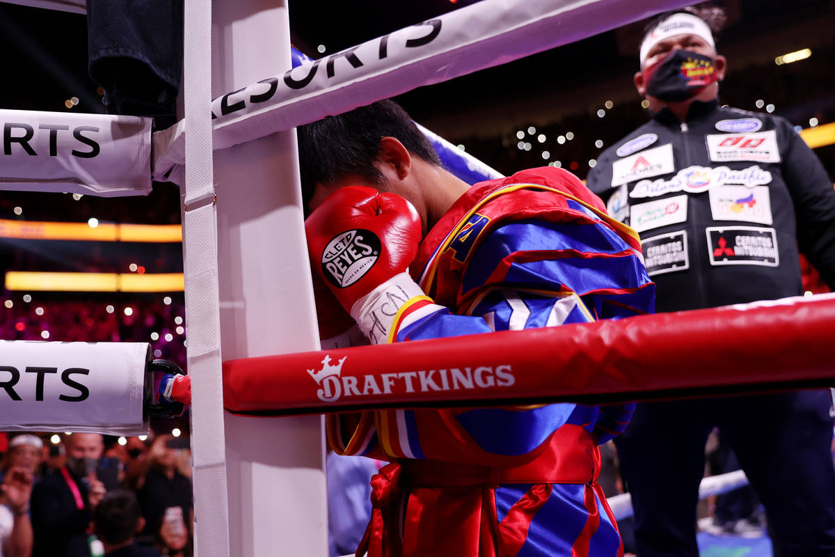Manny Pacquiao kneels in a corner before the start of the WBA World Welterweight Title bout aga ...