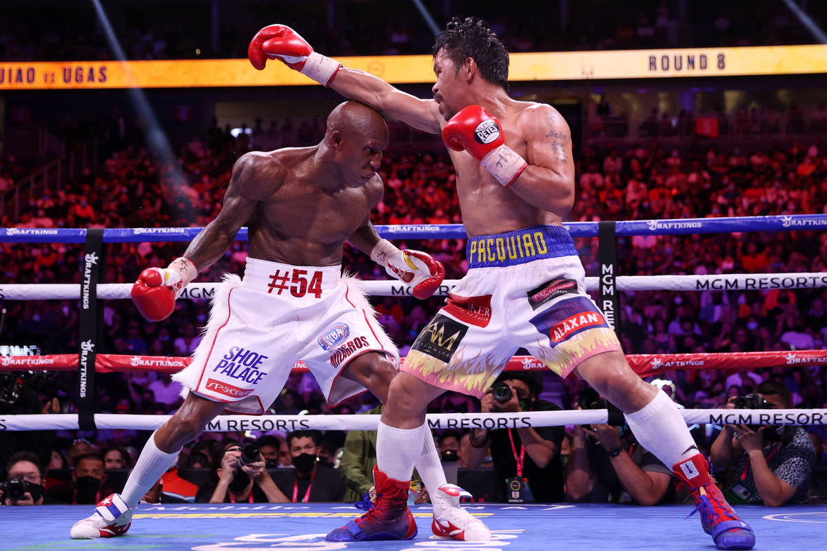 Yordenis Ugas, left, battles Manny Pacquiao in the eighth round of the WBA World Welterweight T ...