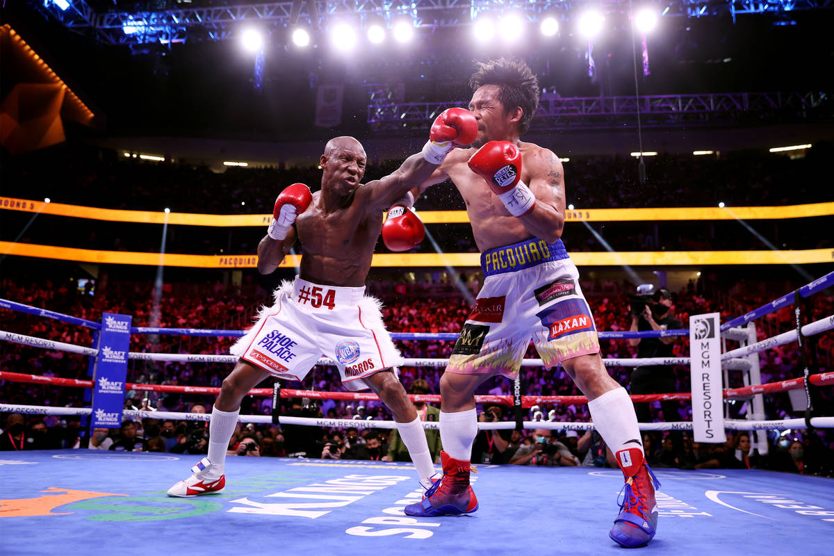 Yordenis Ugas, left, connects a punch against Manny Pacquiao in the fifth round of the WBA Worl ...