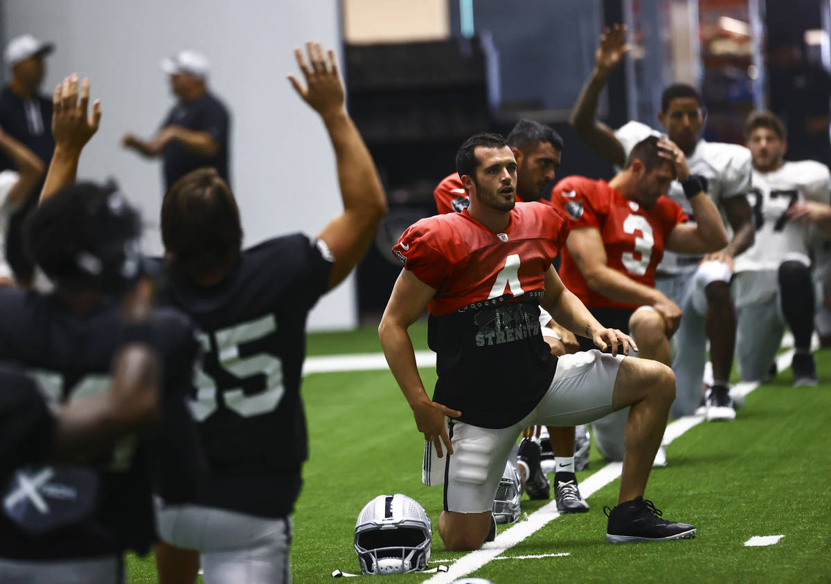 Raiders quarterback Derek Carr stretches during training camp at Raiders Headquarters/Intermoun ...