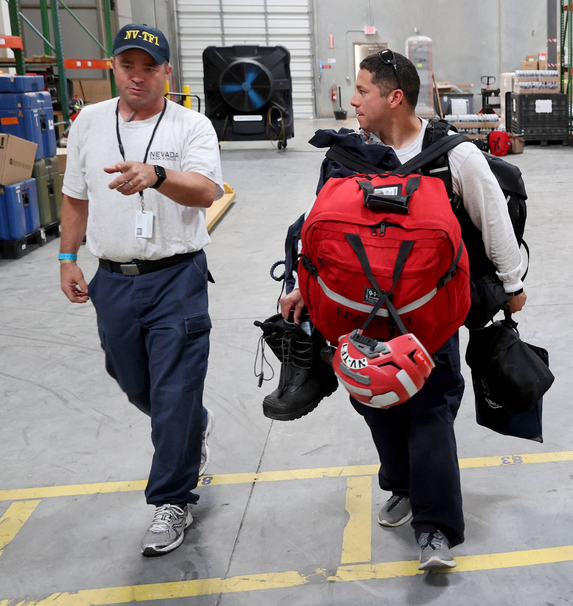 Members of the FEMA Nevada Task Force 1 Urban Search & Rescue team, including Henderson Fir ...