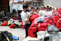 Members of the FEMA Nevada Task Force 1 Urban Search & Rescue team load equipment at their ...