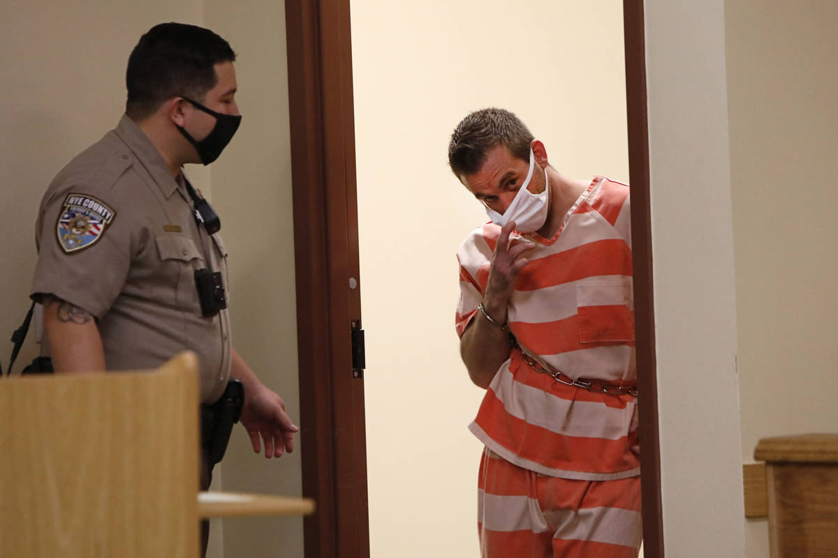 Kevin Dent, right, enters the courtroom for his hearing at Pahrump Justice Court on Thursday, S ...