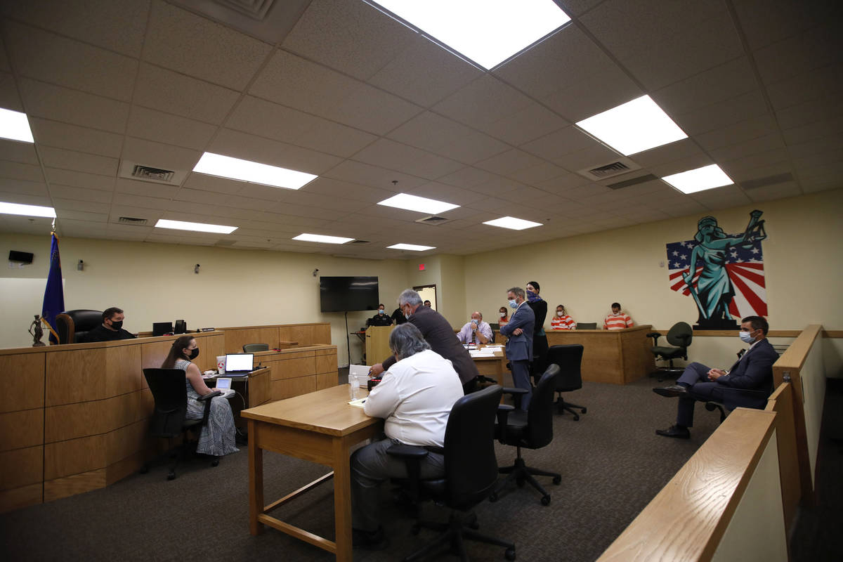 Pahrump Justice of the Peace Kent Jasperson, far left, listens to prosecutor Kirk Vitto, second ...