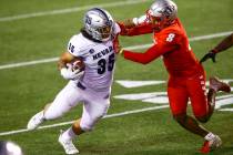 UNR Wolf Pack running back Toa Taua (35) runs the ball against New Mexico Lobos cornerback Dont ...