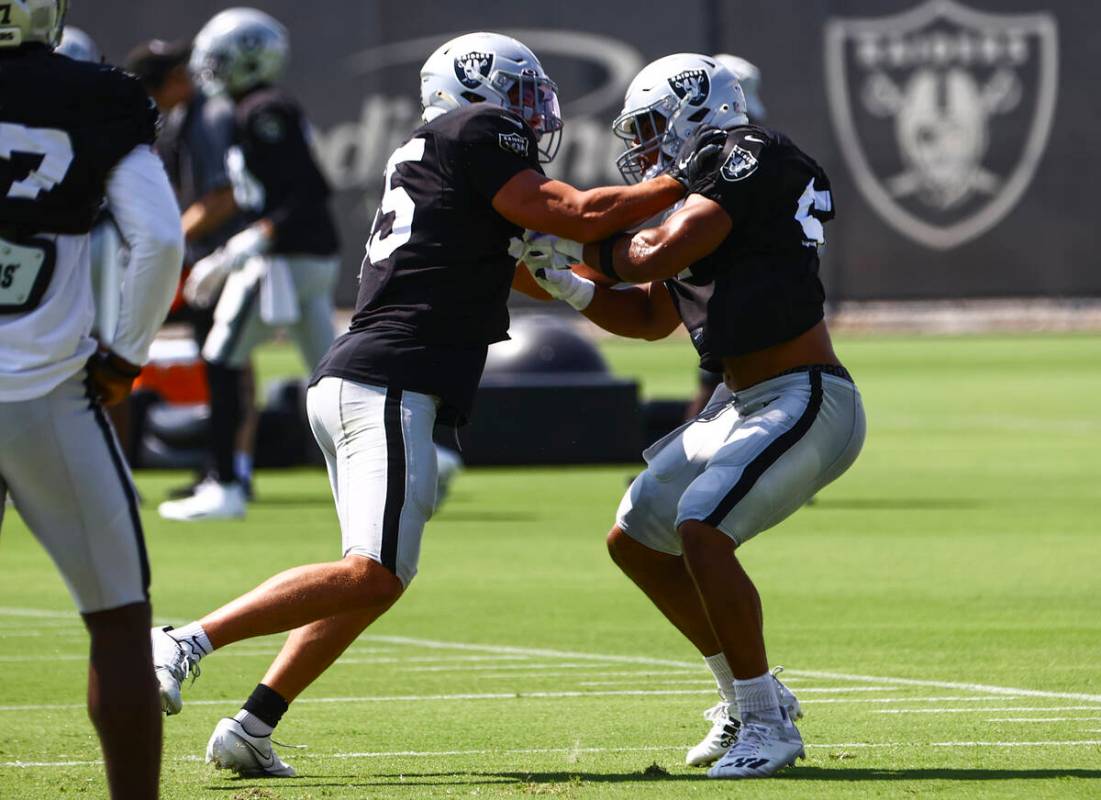 Raiders linebackers Tanner Muse, left, and Max Richardson participate in drills during training ...