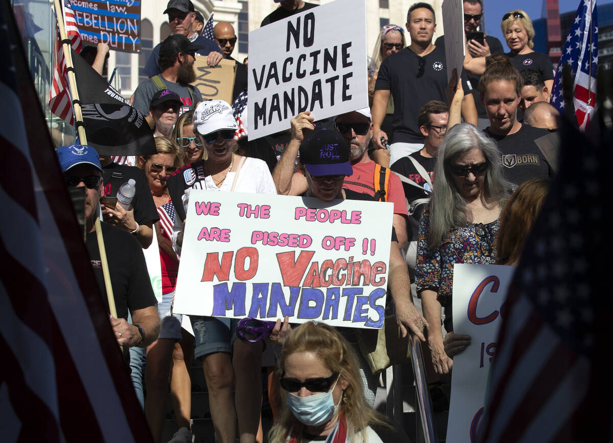 Demonstrators march on the Las Vegas Strip during an anti-mask, anti-vaccination and freedom of ...