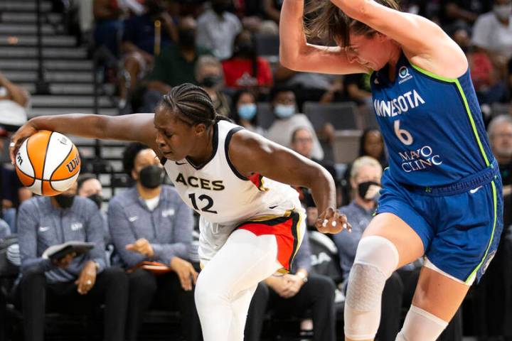 Las Vegas Aces guard Chelsea Gray (12) dribbles toward the hoop while Minnesota Lynx forward Br ...