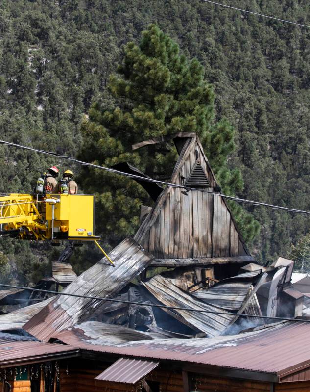 The Clark County firefighters investigate the cause of a fire that damaged Mount Charleston Lod ...