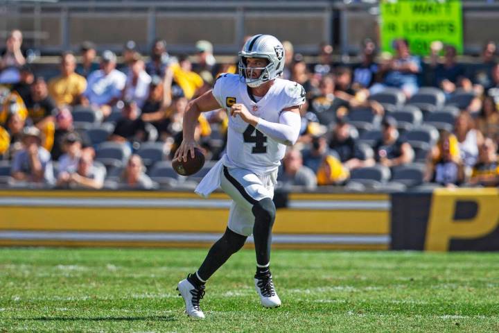 Raiders quarterback Derek Carr (4) scrambles with the football during the third quarter of an N ...