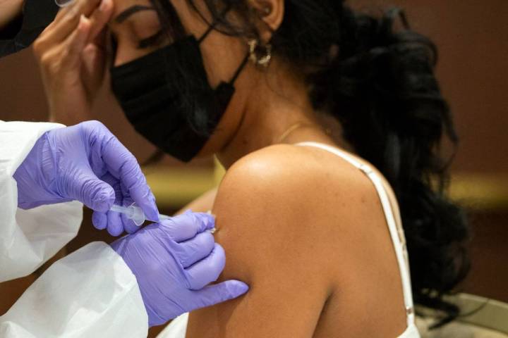 Selam Shumie, a cocktail server at Resorts World Las Vegas, receives her COVID-19 vaccination d ...