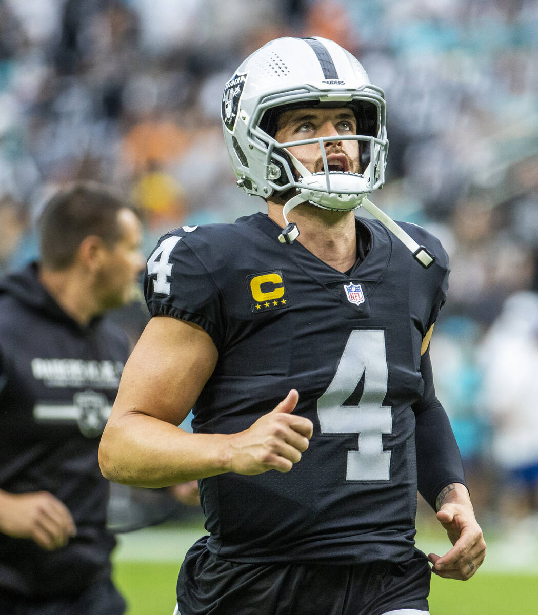 Raiders quarterback Derek Carr (4) runs out for another offensive series during the first half ...