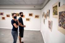 Special to the Pahrump Valley Times Visitors at the Beatty Museum view images from local Beatt ...