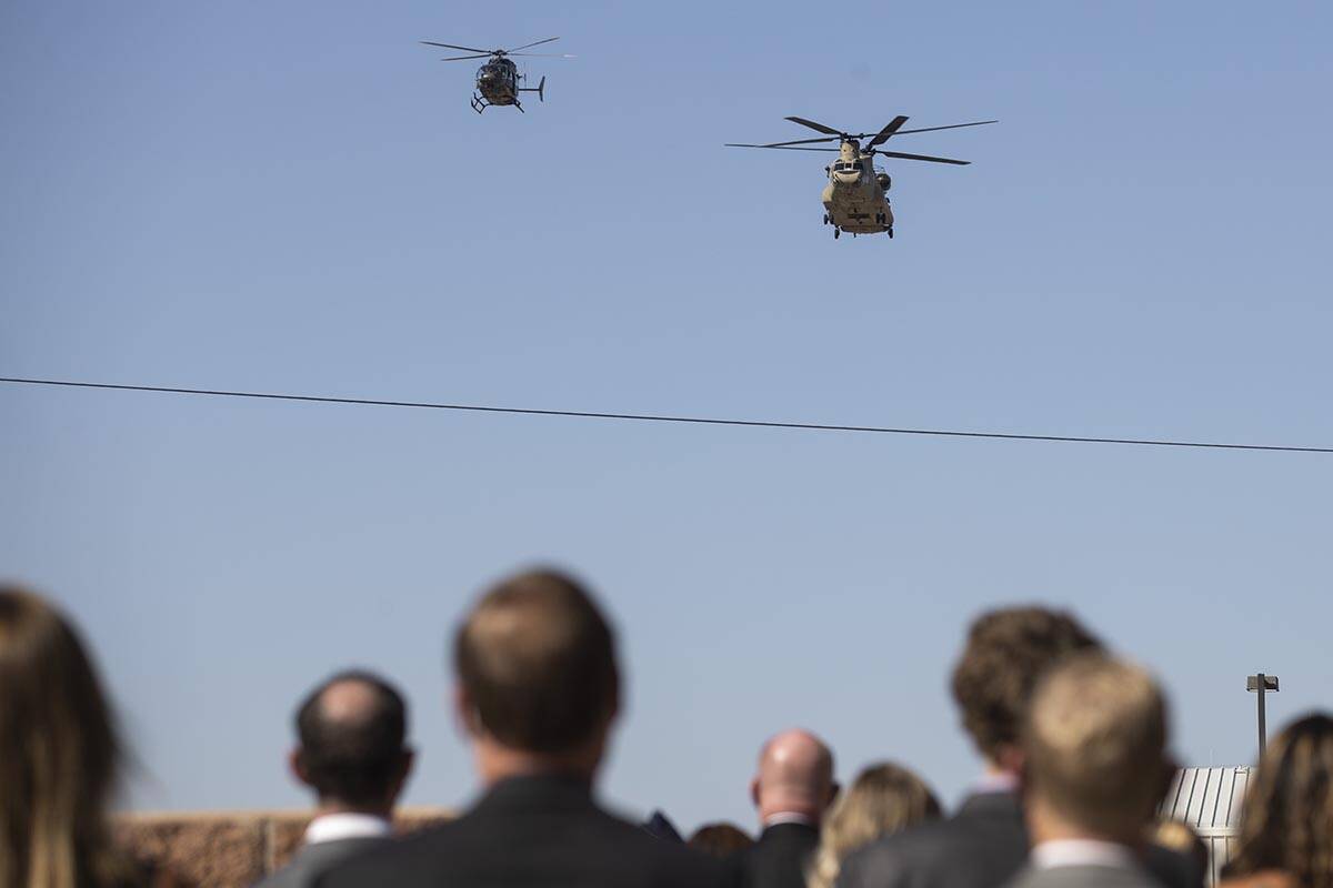 A Chinook and Lakota helicopters conduct a fly over before the start of a ceremony to honor the ...