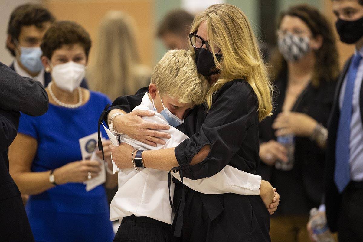 Karen Wayland, right, hugs her nephew Levi, 11, during a ceremony to honor the memory of her l ...