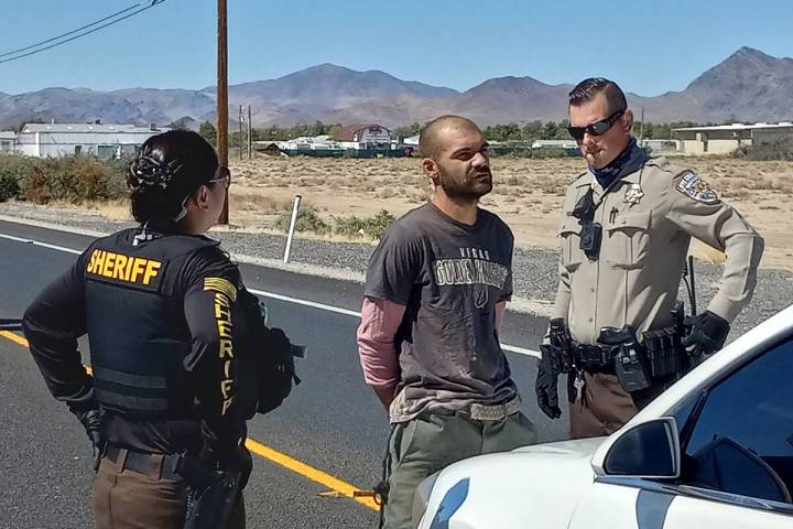 Selwyn Harris/Pahrump Valley Times Nye County Sheriff's Office deputies speak to Noel Mihalcean ...