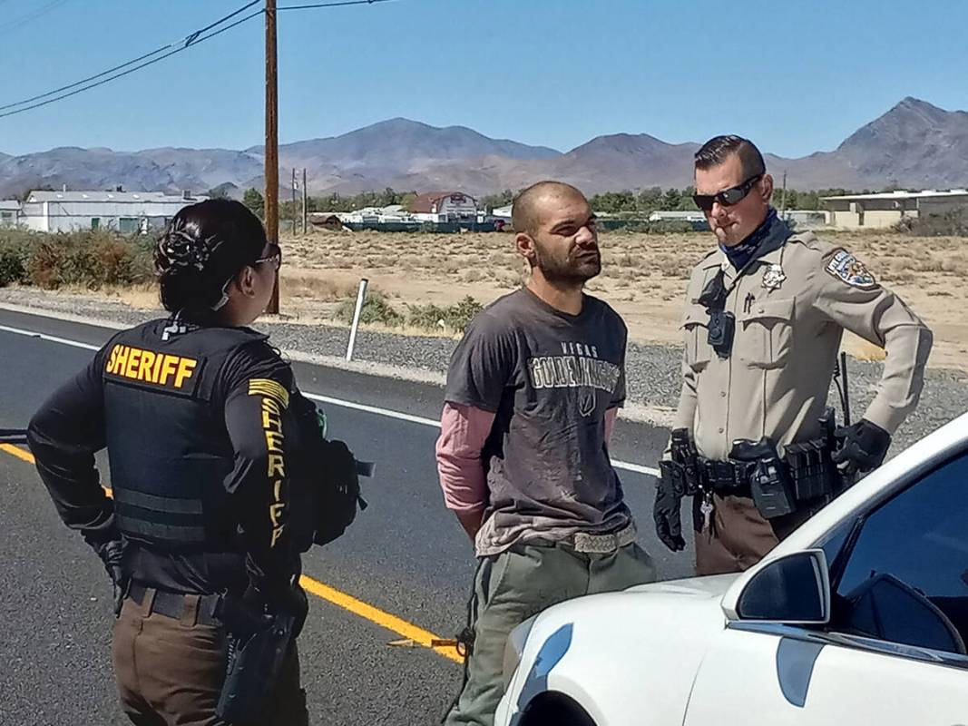 Selwyn Harris/Pahrump Valley Times Nye County Sheriff's Office deputies speak to Noel Mihalcean ...